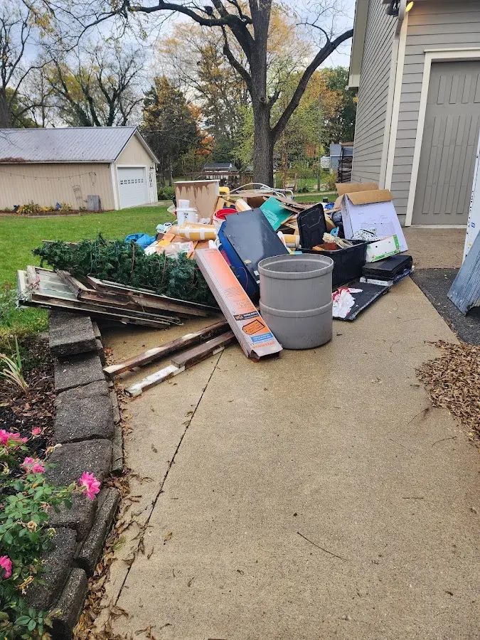 Dumpster being loaded with debris for Estate Cleanout Dumpster Rental in Greenhills